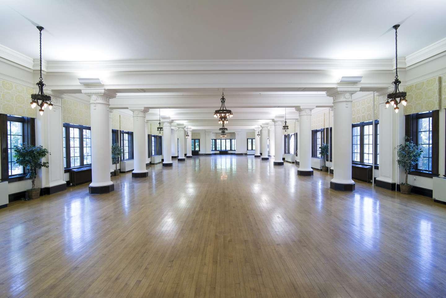 The beautiful, large Le Fer Hall Ballroom with the chandeliers, columns and wood floors.